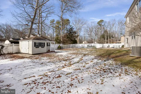 a view of a house with a yard covered in snow