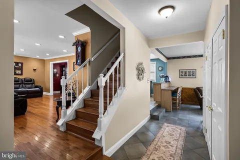 a view of entryway and hall with wooden floor