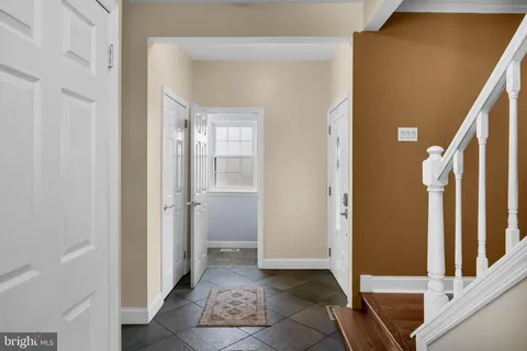 a view of a hallway with wooden floor and entryway