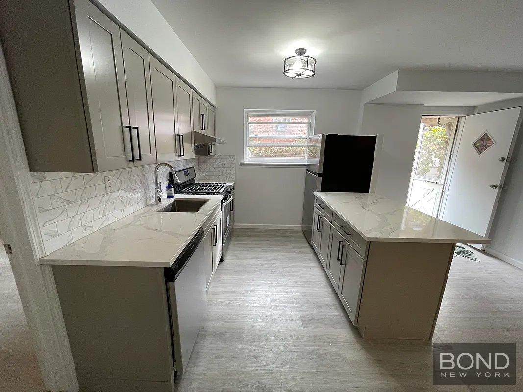 45 Monitor Street, Unit 1 Brooklyn, NY 11222 - Photo 2 of 12 a kitchen with a stove a sink and a microwave