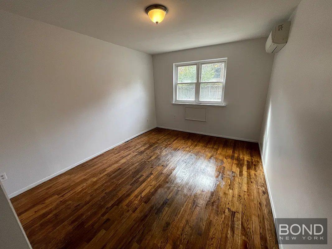 45 Monitor Street, Unit 1 Brooklyn, NY 11222 - Photo 8 of 12 an empty room with wooden floor and windows