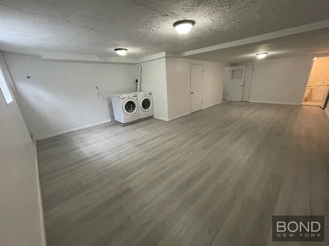 45 Monitor Street, Unit 1 Brooklyn, NY 11222 - Photo 10 of 12 an empty room with wooden floor and windows