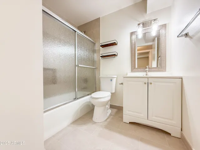 a bathroom with a toilet sink and a mirror