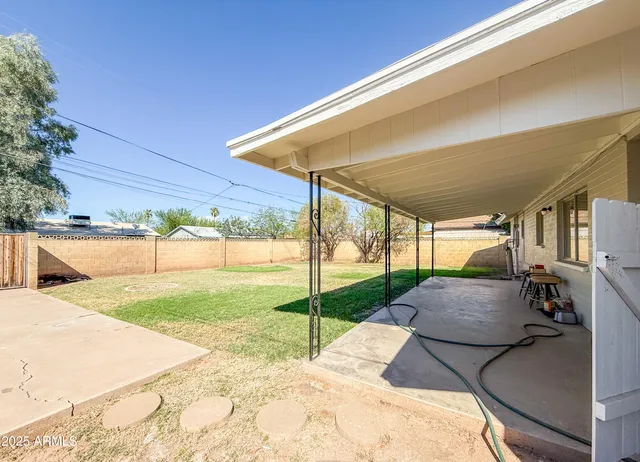 a view of backyard with swimming pool and furniture