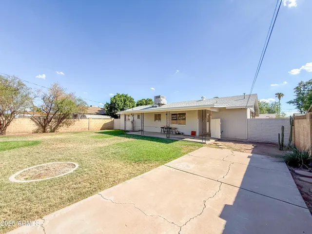a swimming pool with outdoor seating and yard