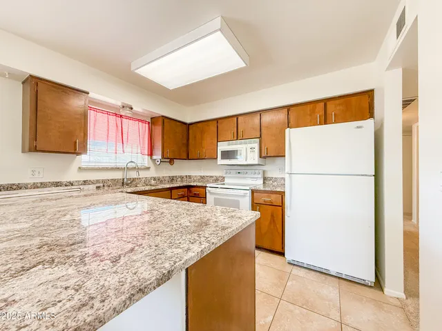 a kitchen with refrigerator and window