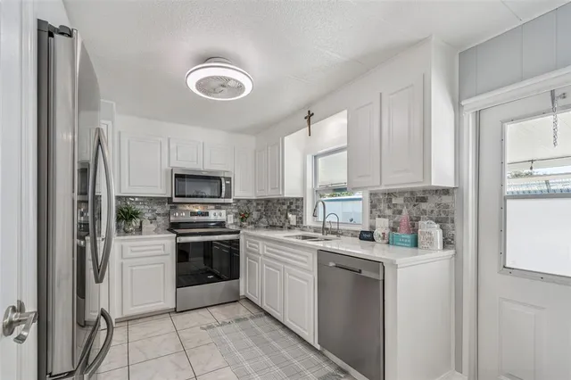 a kitchen with a stove sink and refrigerator
