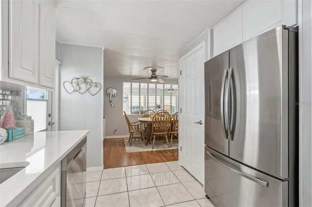 a kitchen with stainless steel appliances granite countertop a refrigerator and a stove