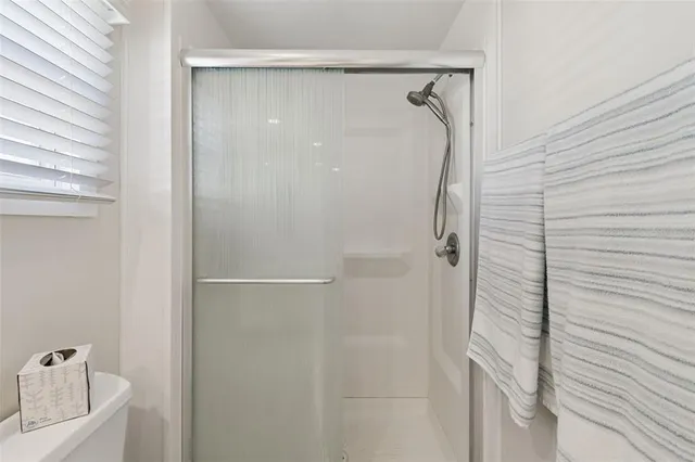 a bathroom with a glass shower door