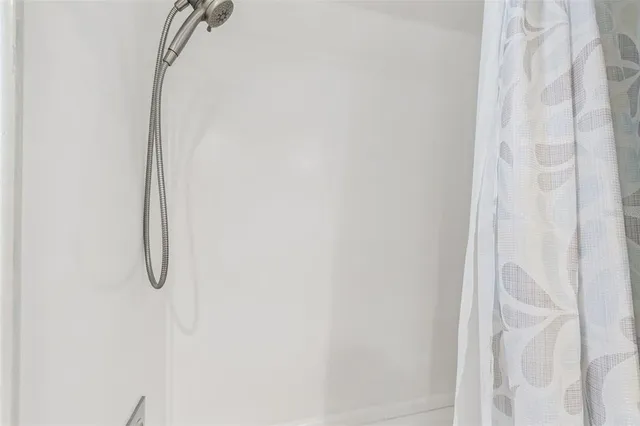 a bathroom with a glass shower door
