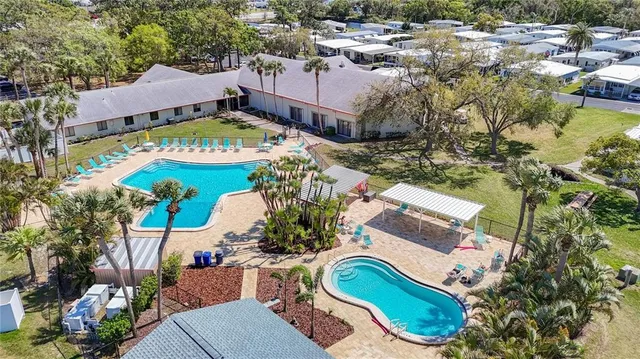 an aerial view of a house a yard and outdoor seating