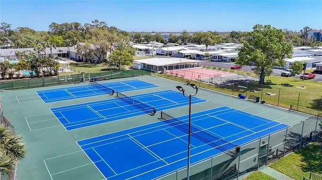 a view of a tennis court with sitting area