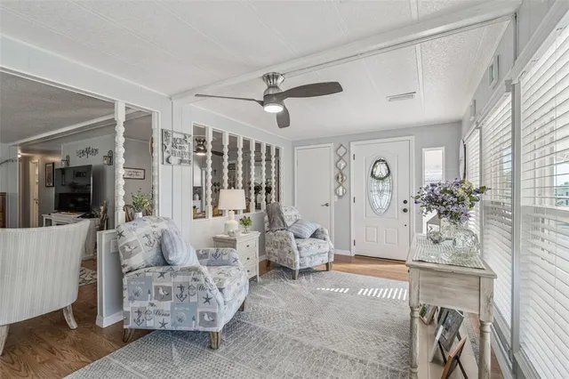 a living room with furniture and a chandelier