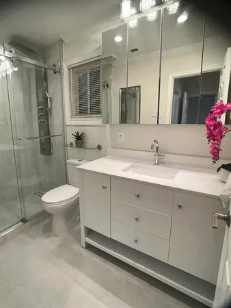 a bathroom with a toilet sink and shower
