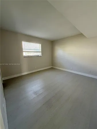 an empty room with a empty space and windows