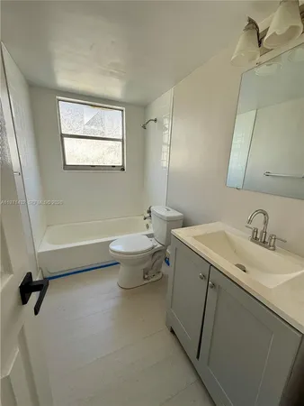 a bathroom with a sink toilet and a mirror