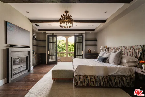 a bedroom with a bed and a large window