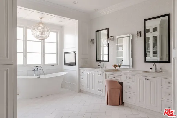 a spacious bathroom with a double vanity sink a mirror and a bathtub
