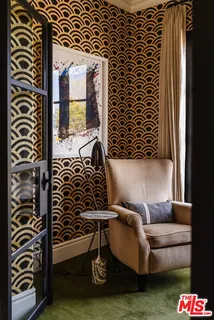 a living room with a couch and a potted plant