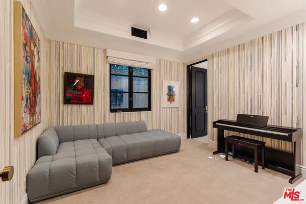 a living room with furniture and a piano
