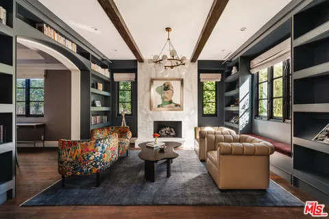 a living room with furniture fireplace and flat screen tv