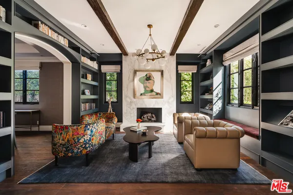 a living room with furniture fireplace and flat screen tv