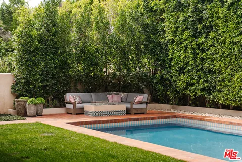 a view of a patio with couches and a fire pit