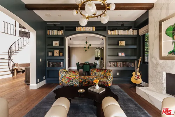 a living room with furniture fireplace and book shelf