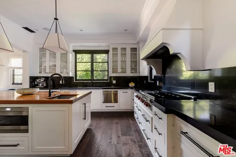 a kitchen with a sink and stove