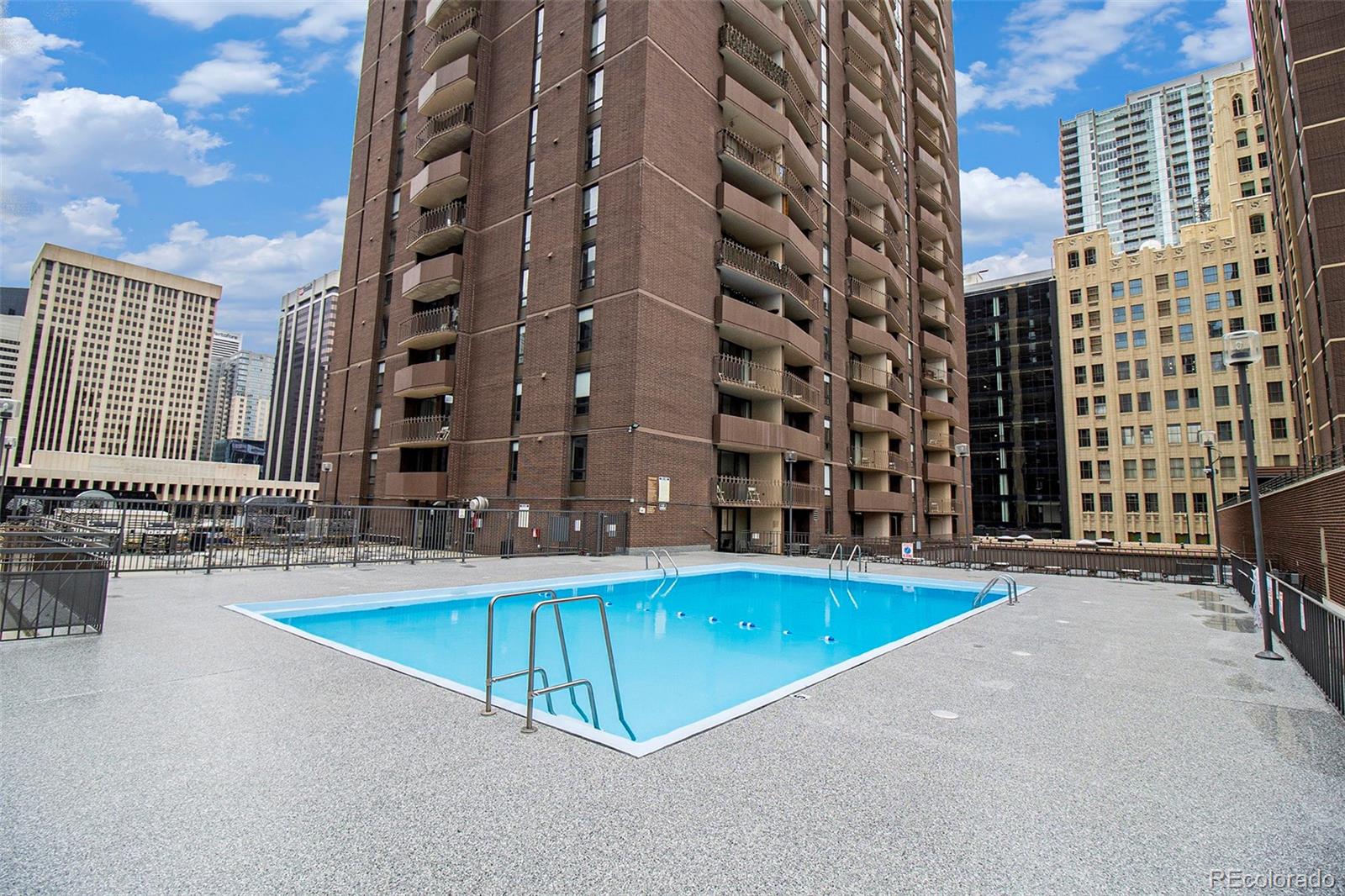 1020 15th Street, Unit 21L Denver, CO 80202 - Photo 19 of 35 an outdoor space with pool and tables and chairs