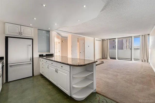 a kitchen with stainless steel appliances granite countertop a refrigerator and a stove