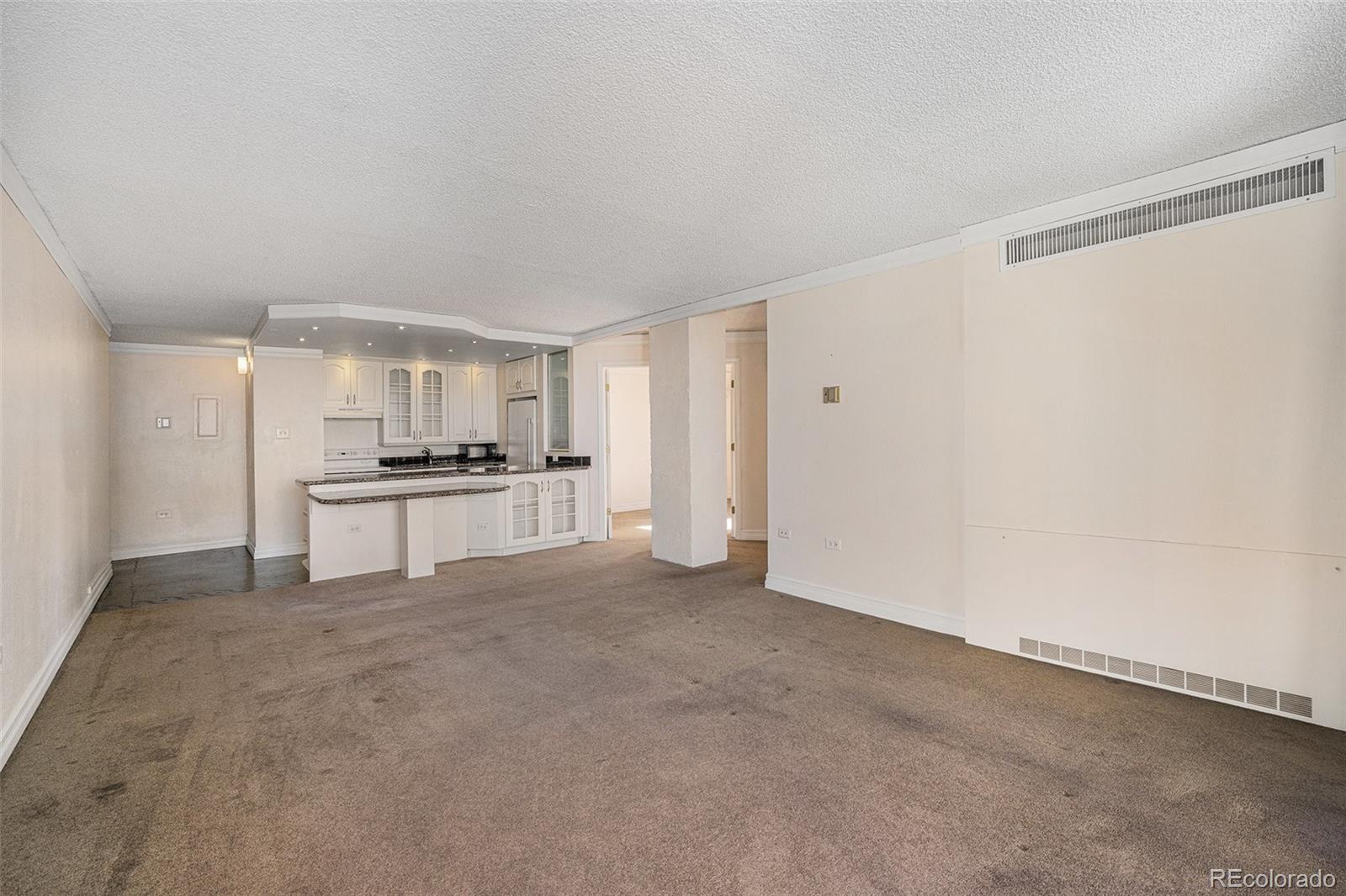 1020 15th Street, Unit 21L Denver, CO 80202 - Photo 4 of 35 a view of kitchen with refrigerator and white cabinets