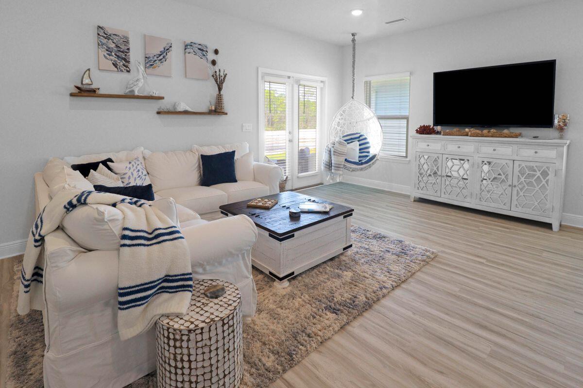 769 Backwater Road Port St. Joe, FL 32456 - Photo 11 of 45 a living room with furniture and a flat screen tv
