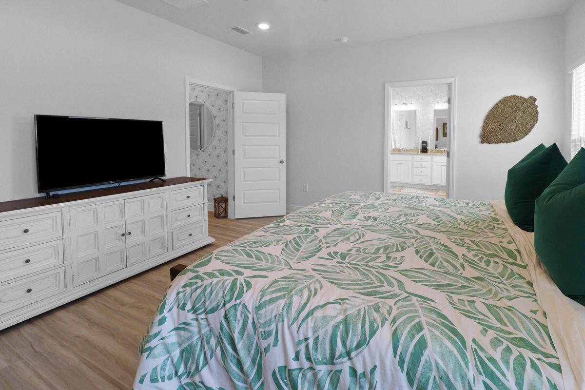 769 Backwater Road Port St. Joe, FL 32456 - Photo 21 of 45 a bedroom with a bed and a flat screen tv in it