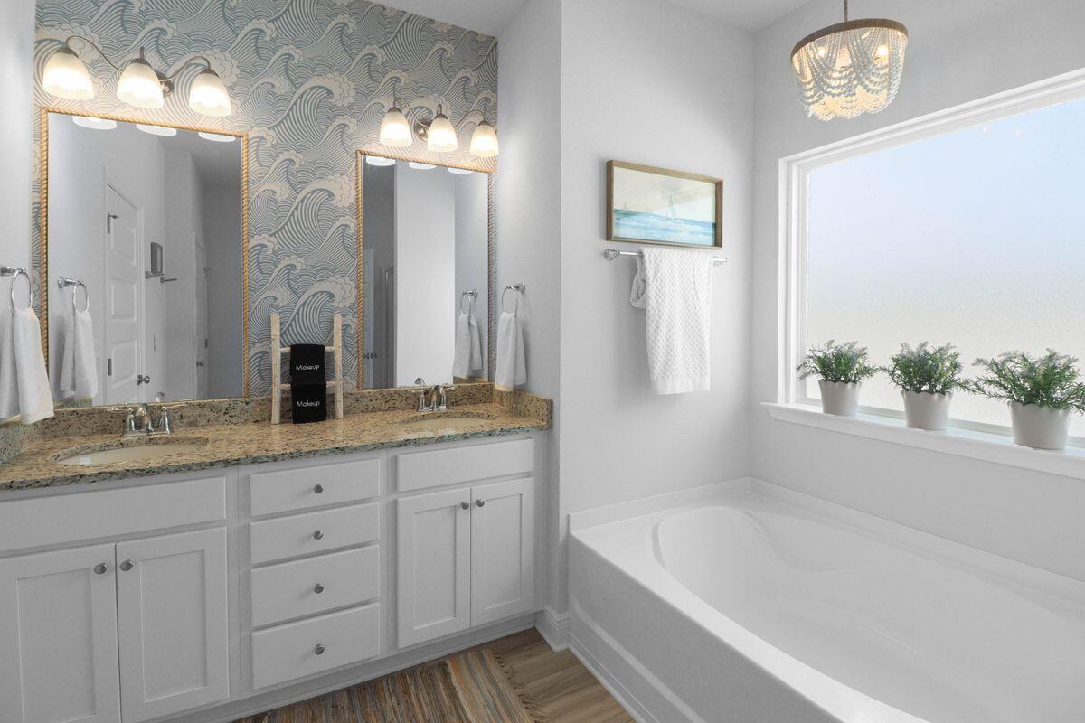 769 Backwater Road Port St. Joe, FL 32456 - Photo 22 of 45 a bathroom with a tub a sink and a large mirror