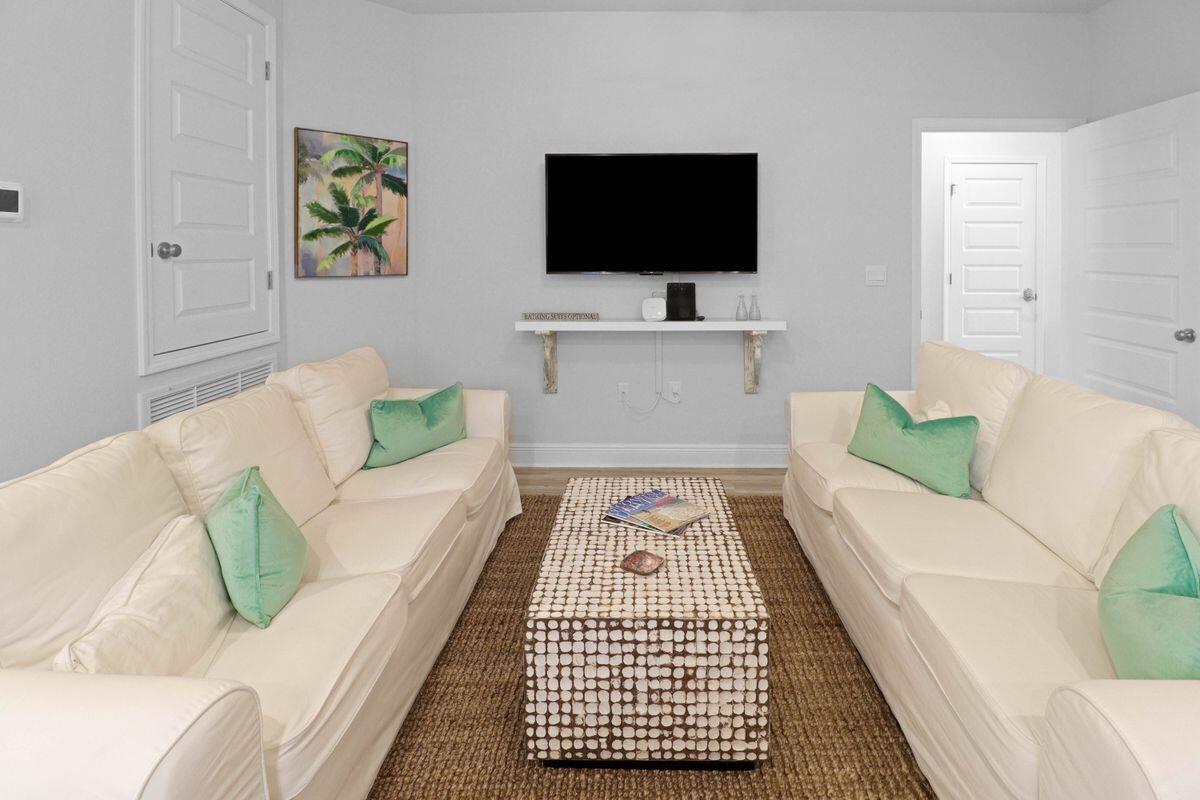 769 Backwater Road Port St. Joe, FL 32456 - Photo 24 of 45 a living room with furniture and a flat screen tv