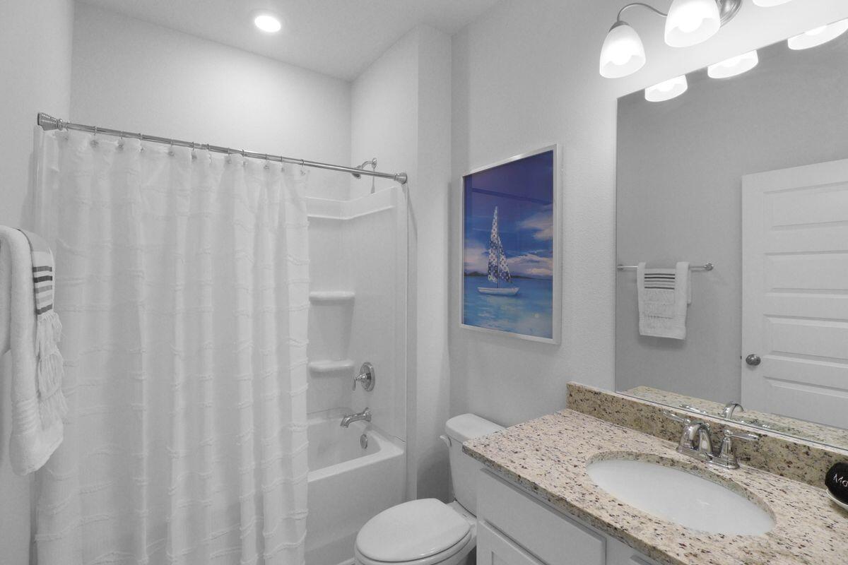 769 Backwater Road Port St. Joe, FL 32456 - Photo 27 of 45 a bathroom with a granite countertop sink toilet and shower