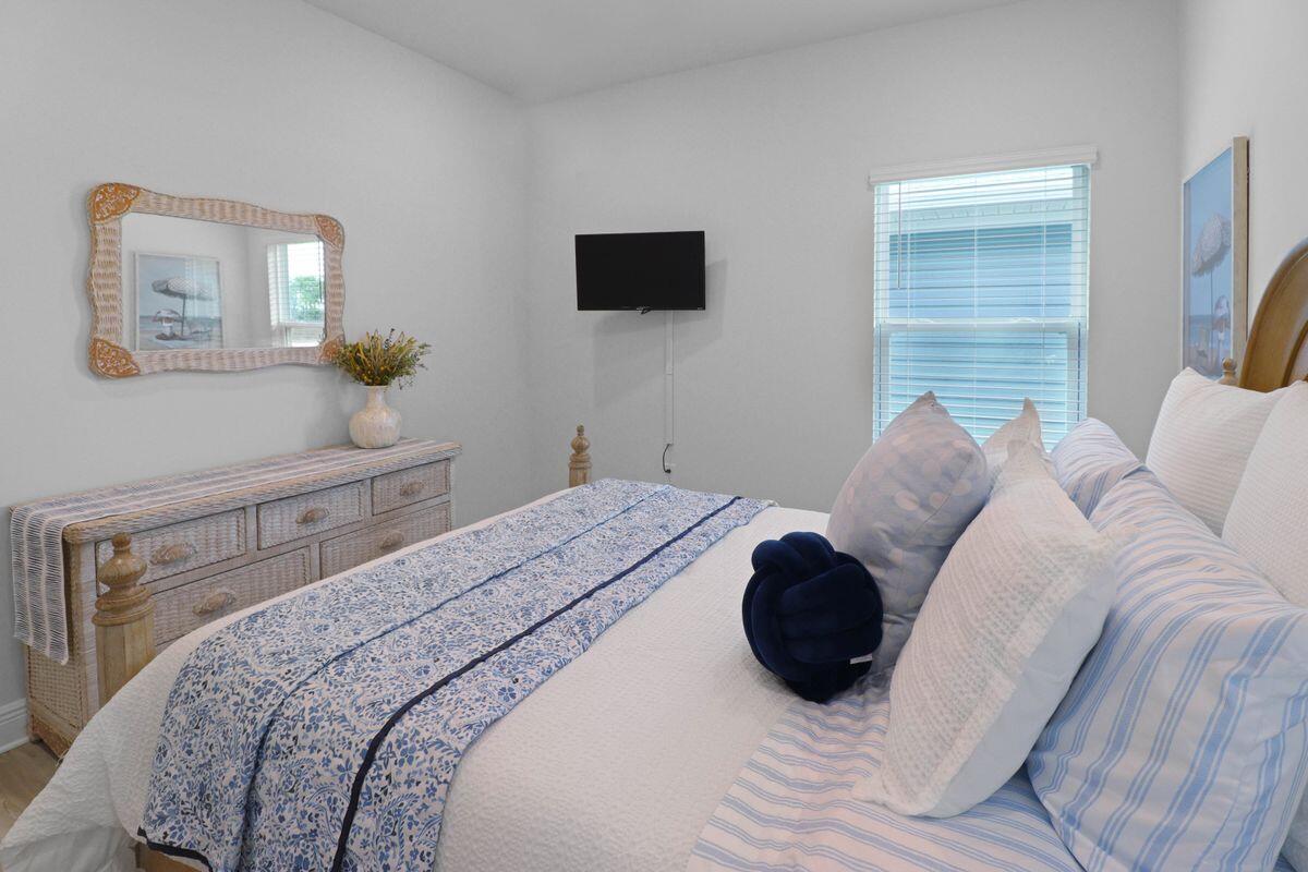 769 Backwater Road Port St. Joe, FL 32456 - Photo 28 of 45 a bedroom with a bed a window and painting on the wall