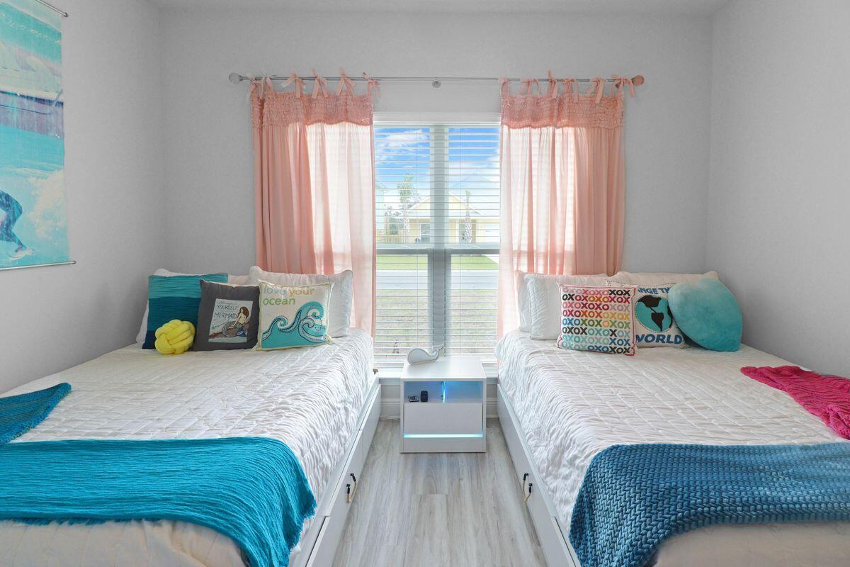 769 Backwater Road Port St. Joe, FL 32456 - Photo 30 of 45 a bedroom with a bed and large windows