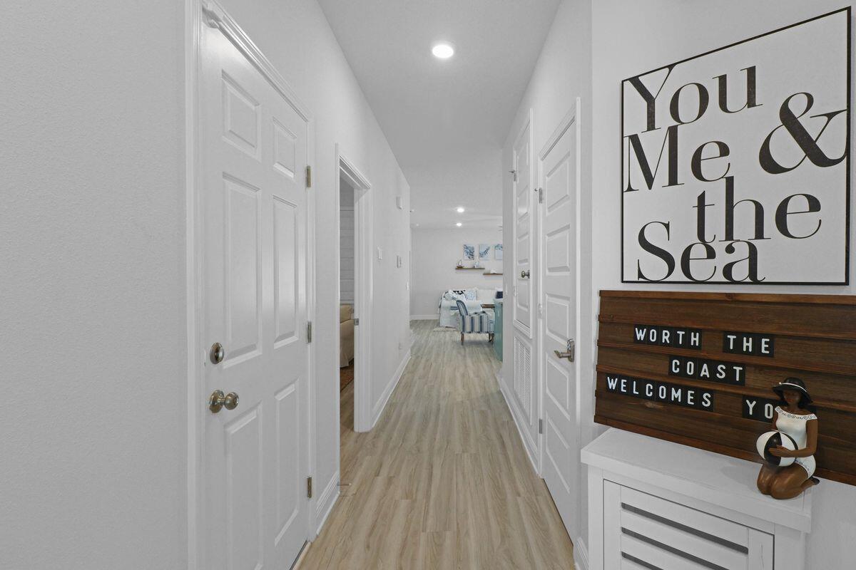 769 Backwater Road Port St. Joe, FL 32456 - Photo 6 of 45 a view of a hallway with wooden floor and stairs