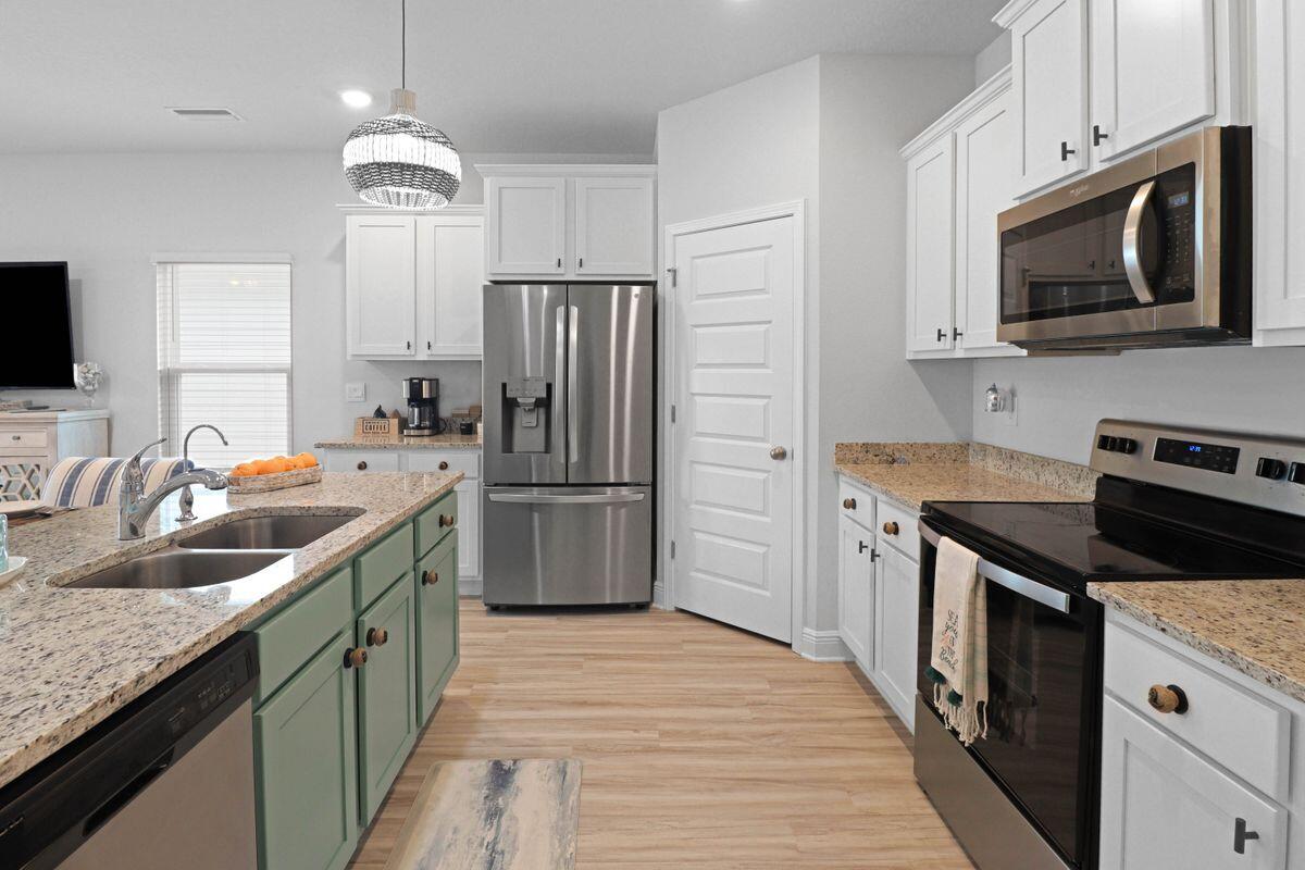 769 Backwater Road Port St. Joe, FL 32456 - Photo 7 of 45 a kitchen with a sink stove and refrigerator