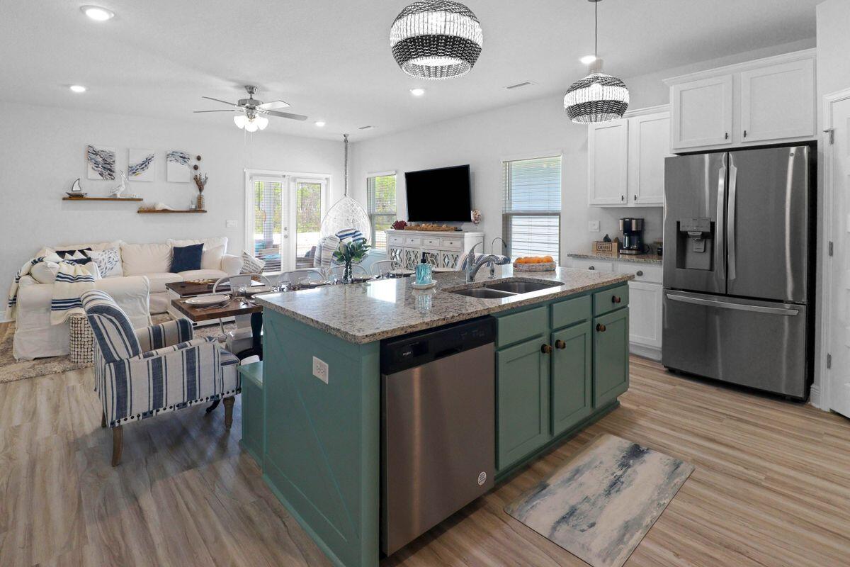 769 Backwater Road Port St. Joe, FL 32456 - Photo 8 of 45 a kitchen with stainless steel appliances granite countertop a sink stove and refrigerator