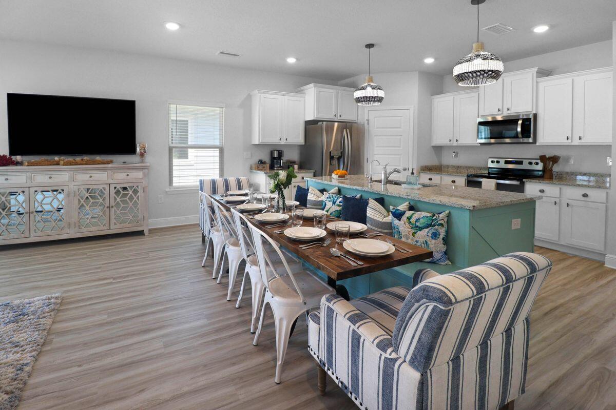 769 Backwater Road Port St. Joe, FL 32456 - Photo 9 of 45 a kitchen with stainless steel appliances kitchen island granite countertop a stove a sink a microwave a refrigerator and a microwave