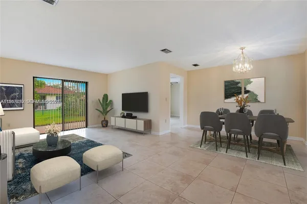 a living room with furniture a flat screen tv and a large window