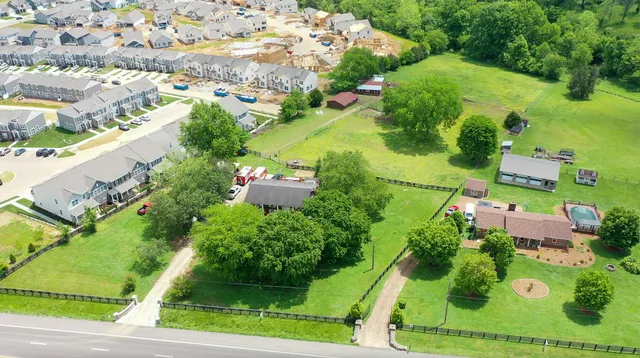 an aerial view of residential houses with outdoor space