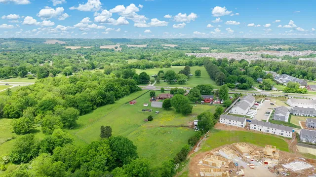 a front view of a house with yard porch and furniture