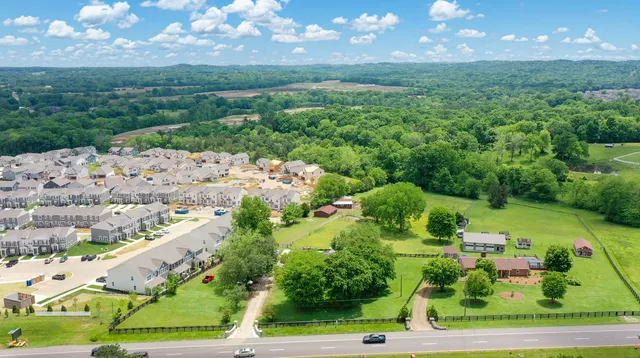 an aerial view of a houses with outdoor space and street view