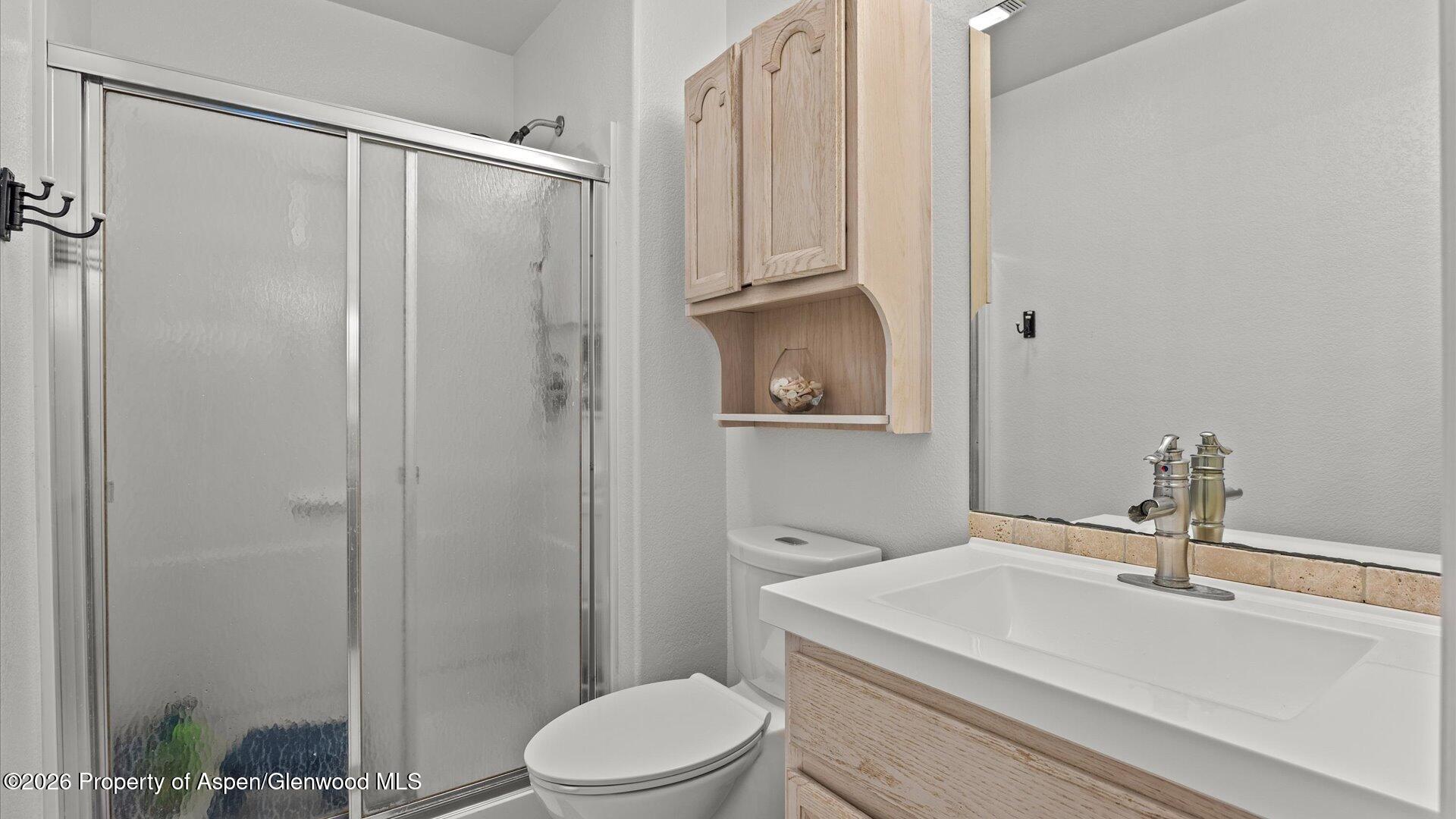 1557 East 12th Street Rifle, CO 81650 - Photo 16 of 26 a bathroom with a sink a toilet and shower