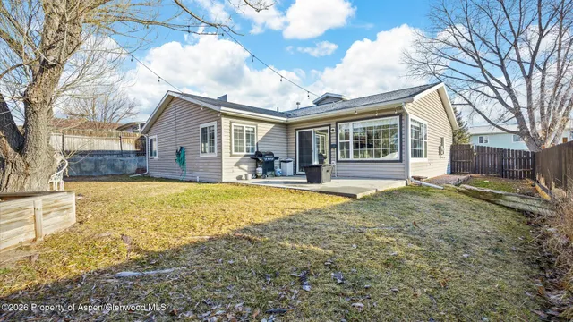 a view of a house with a yard covered with snow