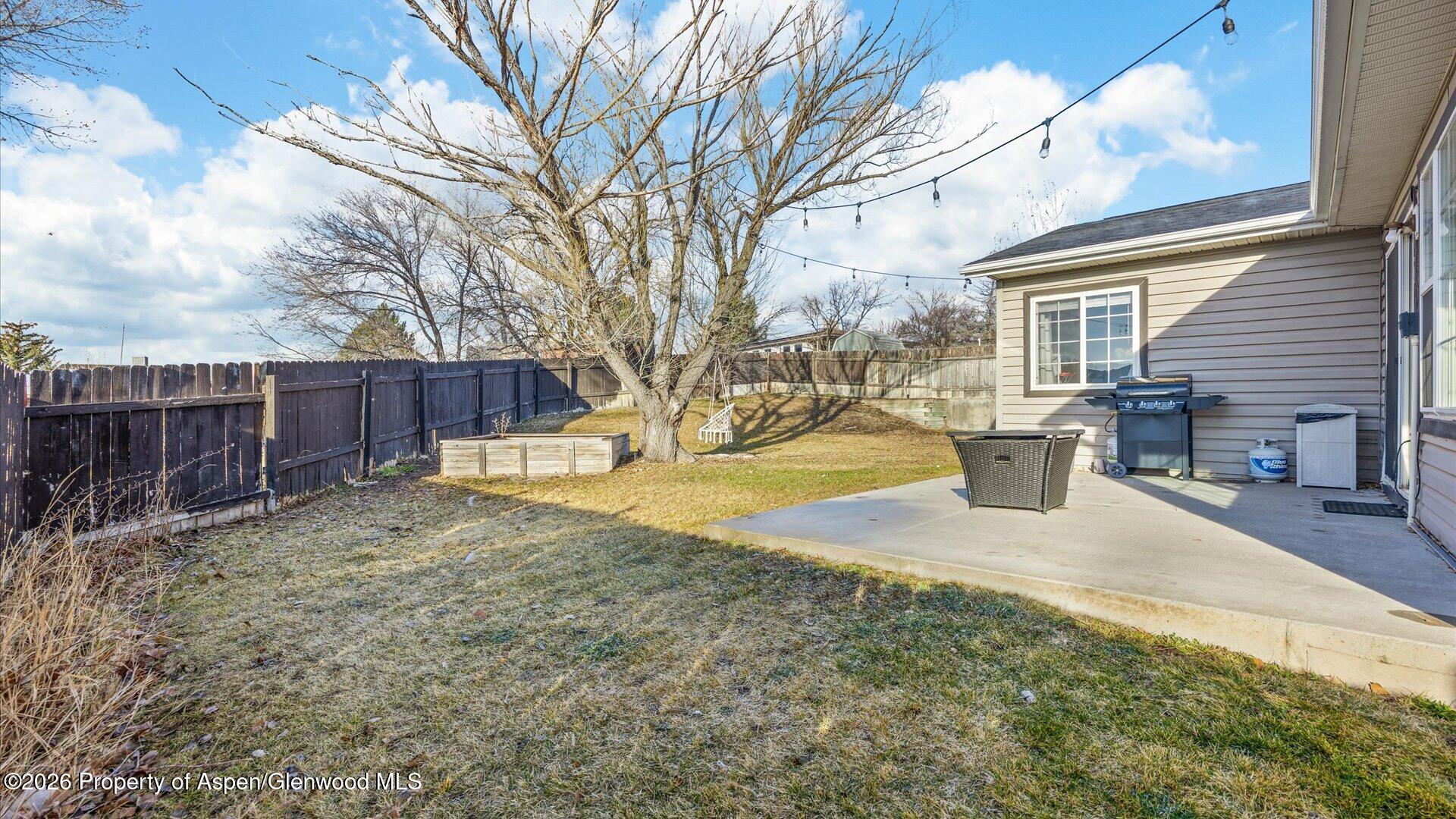 1557 East 12th Street Rifle, CO 81650 - Photo 23 of 26 a view of a house with backyard and trees